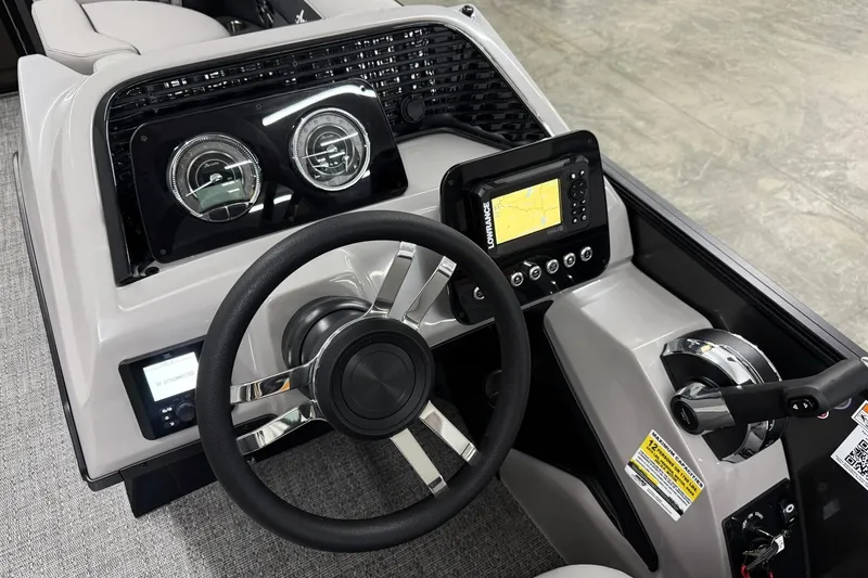 Slide: The Image of 2026 Barletta ARIA 22UC boat dashboard with steering wheel and navigation display. - 12