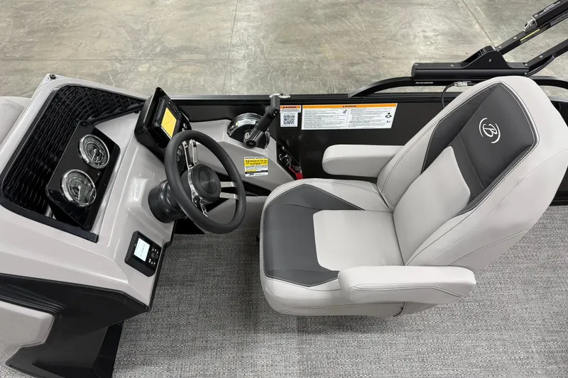 Slide: The Image of 2026 Barletta ARIA 22UC boat cockpit with steering wheel and captain's chair. - 15