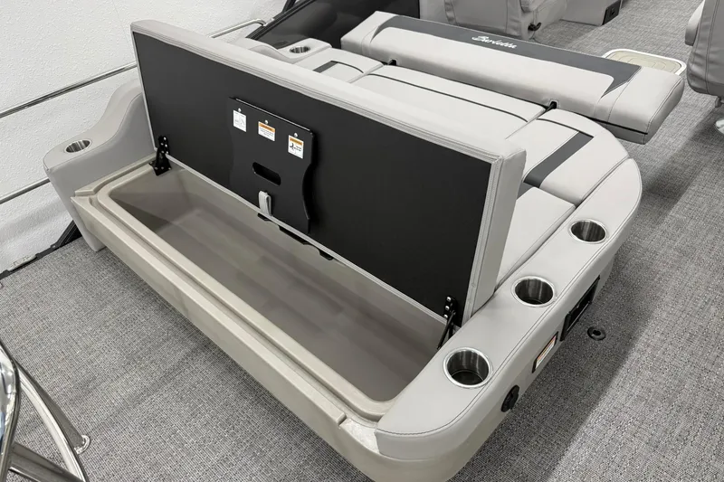Slide: The Image of 2026 Barletta ARIA 22UC boat interior with open storage compartment and cup holders. - 7