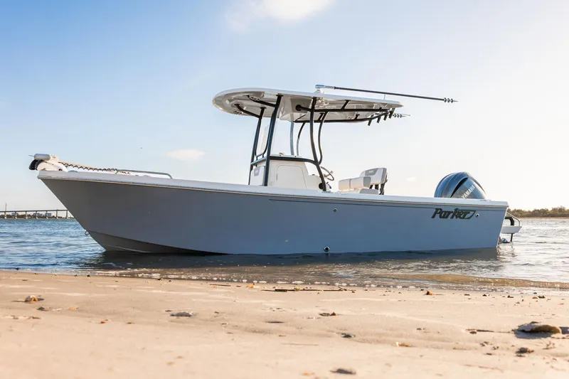 Slide: The Image of Manufacturer Provided Image: 2026 Parker 230 Coastal Elite boat on sandy shore, under clear sky. - 2