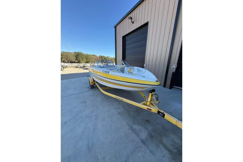 The Image of 2008 Glastron GX 205 boat on trailer outside a storage facility. - 0