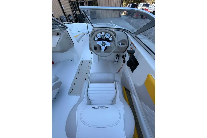 Slide: The Image of 2008 Glastron GX 205 boat interior with steering wheel and dashboard controls. - 7