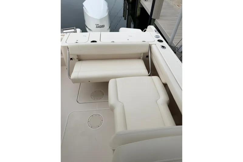 Slide: The Image of 2019 Grady-White Freedom 235 boat interior with cushioned seating and Yamaha 300 outboard motor. - 10
