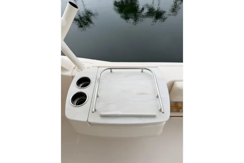 Slide: The Image of 2019 Grady-White Freedom 235 boat with cup holders and railing by the water. - 12