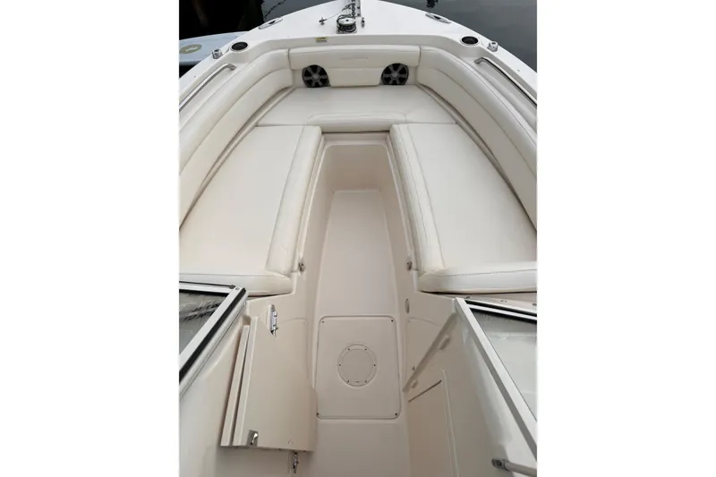 Slide: The Image of 2019 Grady-White Freedom 235 boat interior with white seating and storage compartments. - 19