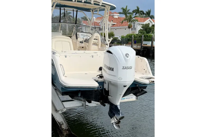 Slide: The Image of 2019 Grady-White Freedom 235 boat with Yamaha 300 outboard motor, docked near waterfront homes. - 3