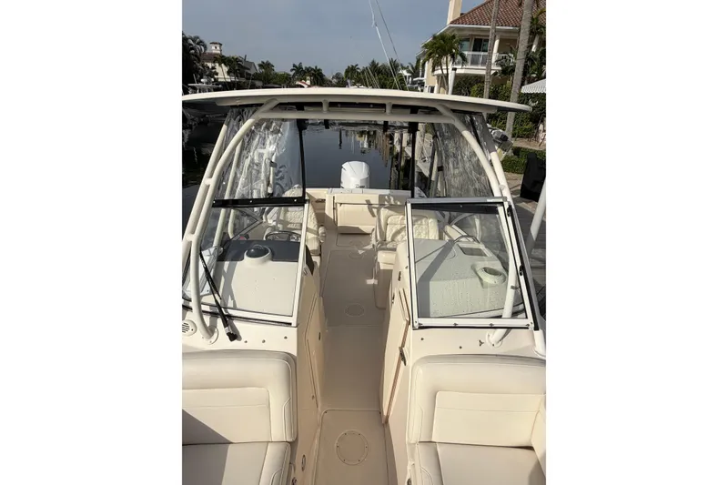Slide: The Image of 2019 Grady-White Freedom 235 boat interior, docked in a scenic waterfront setting. - 5