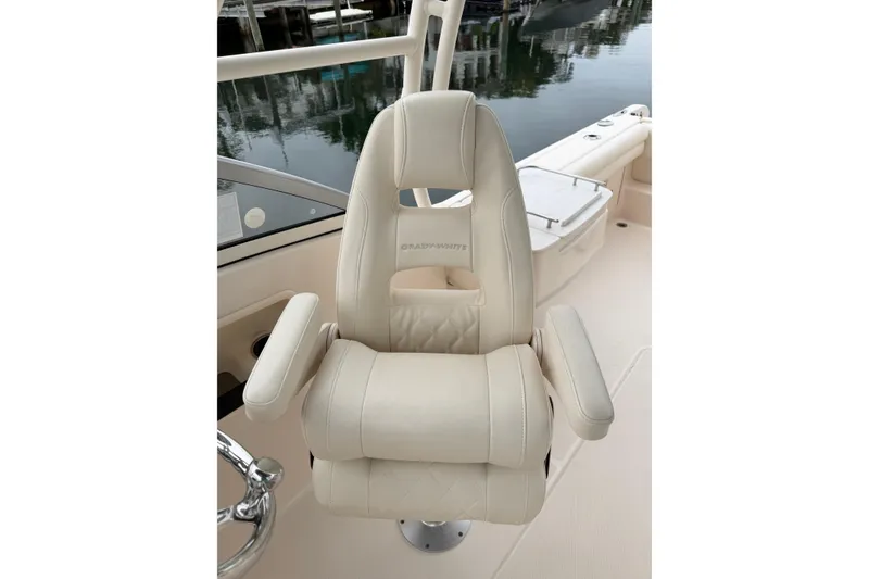 Slide: The Image of Captain's chair on 2019 Grady-White Freedom 235 boat, featuring luxurious beige upholstery. - 9