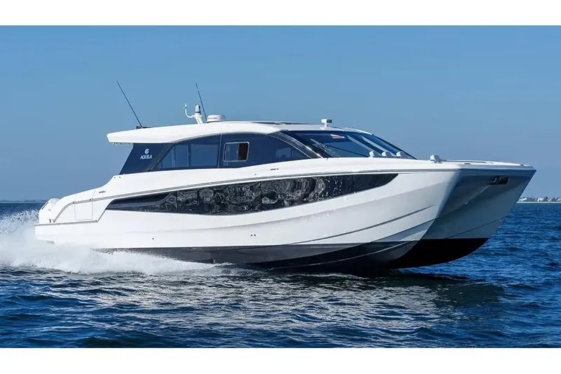 Slide: The Image of Manufacturer Provided Image: 2026 Aquila 46 Coupe yacht cruising on open water under clear blue sky. - 1