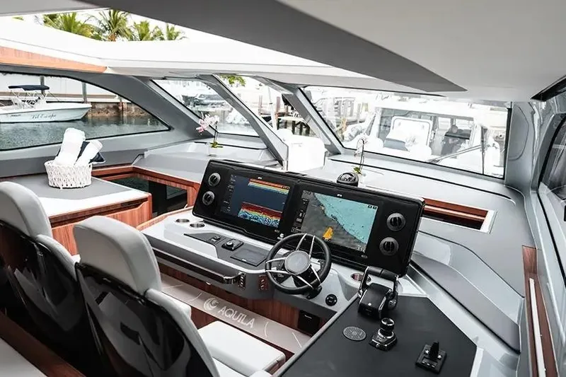 Slide: The Image of Manufacturer Provided Image: Interior of 2026 Aquila 46 Coupe yacht with modern navigation system and luxurious seating. - 5