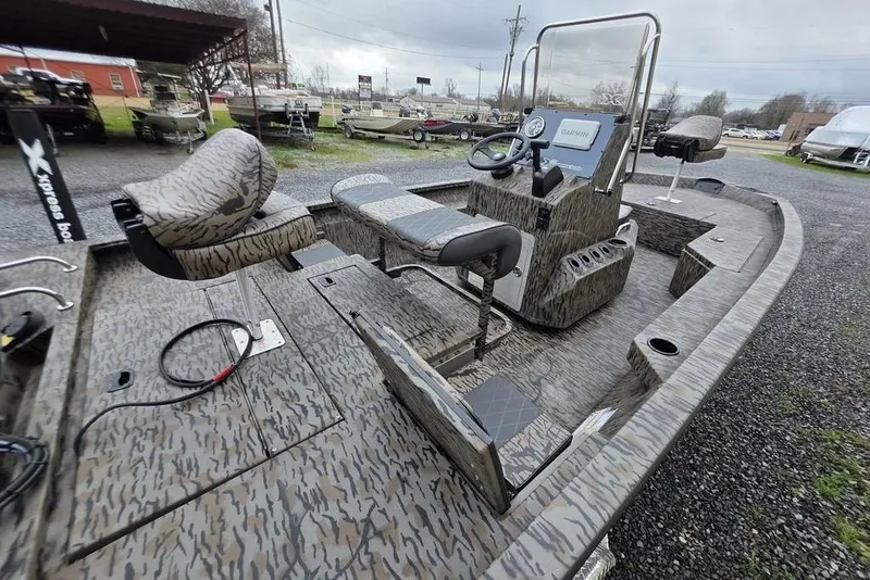 Slide: The Image of 2026 Xpress H20B Bay boat with camo design, featuring a modern console and seating. - 12