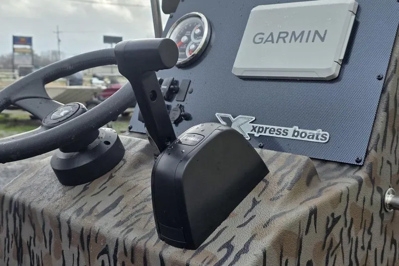Slide: The Image of 2026 Xpress H20B Bay boat dashboard with Garmin navigation system. - 13
