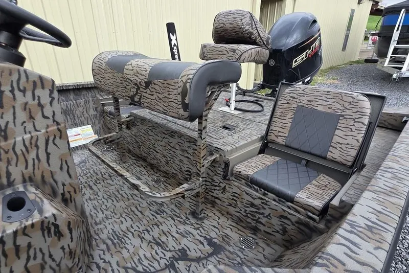 Slide: The Image of 2026 Xpress H20B Bay boat interior with camouflage seating and powerful outboard motor. - 20