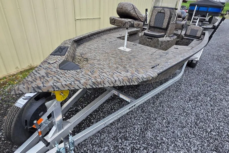 Slide: The Image of 2026 Xpress H20B Bay boat with camouflage design on a trailer. - 4