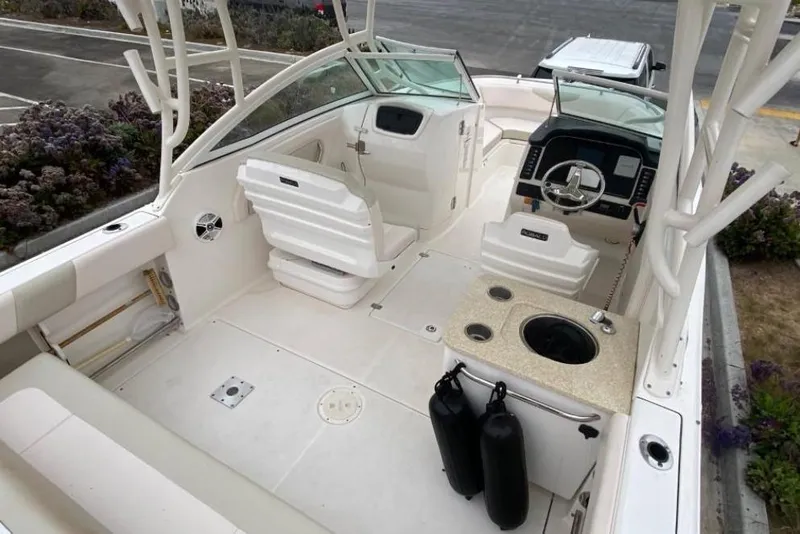 Slide: The Image of 2017 Robalo R247 Dual Console boat interior with seating and steering console. - 4