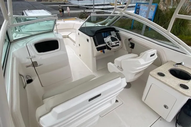 Slide: The Image of 2017 Robalo R247 Dual Console boat interior with helm and seating area. - 5