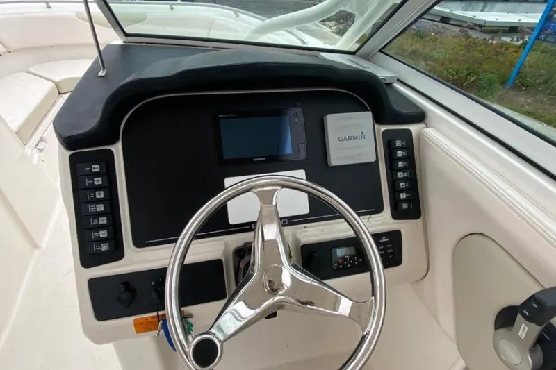 Slide: The Image of 2017 Robalo R247 Dual Console boat dashboard with Garmin navigation system. - 6