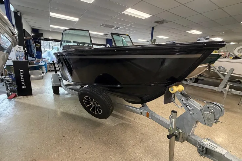 Slide: The Image of 2026 Lund 1700 Explorer Sport boat on display in showroom. - 2