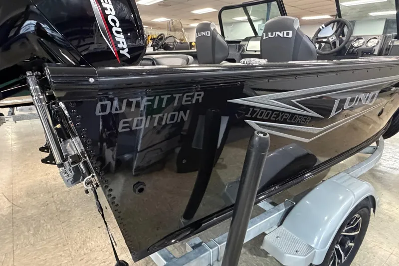 Slide: The Image of 2026 Lund 1700 Explorer Sport boat with Mercury engine on display in showroom. - 4