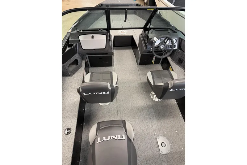 Slide: The Image of 2026 Lund 1700 Explorer Sport boat interior with steering wheel and control panel. - 7