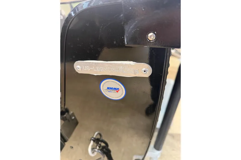 Slide: The Image of 2026 Lund 1700 Explorer Sport boat interior with Mercury 90 engine, featuring three seats. - 9