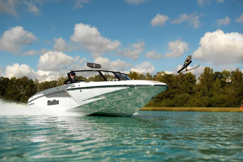 Slide: The Image of 2017 Malibu Response TXi Open Bow towing a water skier on a sunny day. - 10