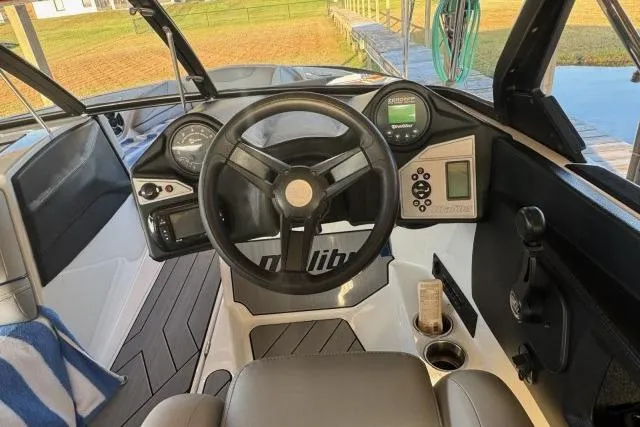 Slide: The Image of 2017 Malibu Response TXi Open Bow boat interior with steering wheel and dashboard controls. - 4