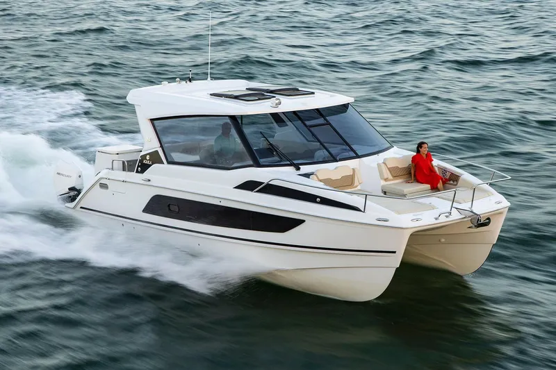 The Image of Manufacturer Provided Image: 2026 Aquila 36 Sport cruising on open water with a person relaxing on deck. - 0