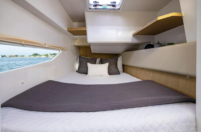 Slide: The Image of Manufacturer Provided Image: Cozy cabin interior of 2026 Aquila 36 Sport yacht with modern bedding and window view. - 13