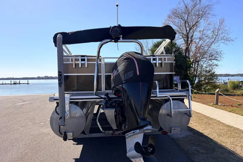 Slide: The Image of 2019 Crestliner 200 Rally CS pontoon boat with outboard motor by a lake. - 14
