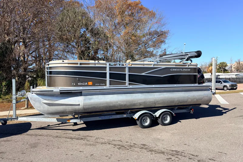 Slide: The Image of 2019 Crestliner 200 Rally CS pontoon boat on trailer, parked outdoors. - 15