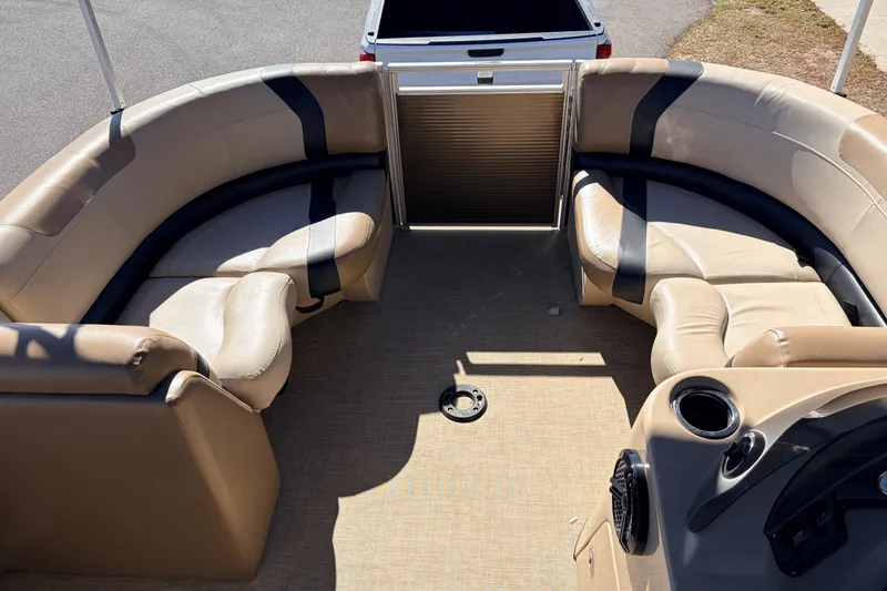 Slide: The Image of 2019 Crestliner 200 Rally CS pontoon boat interior with beige seating and cup holders. - 16
