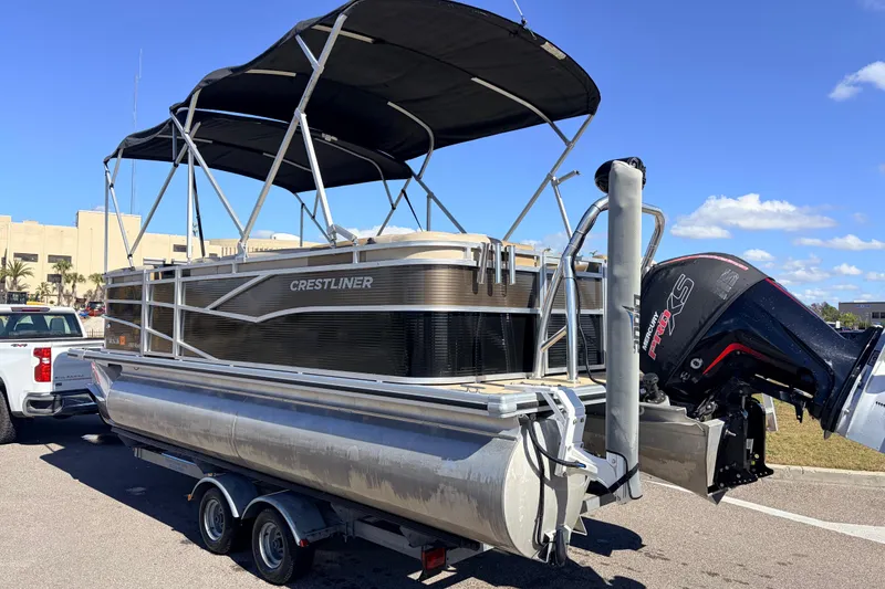 Slide: The Image of 2019 Crestliner 200 Rally CS pontoon boat on trailer with Mercury outboard motor. - 2