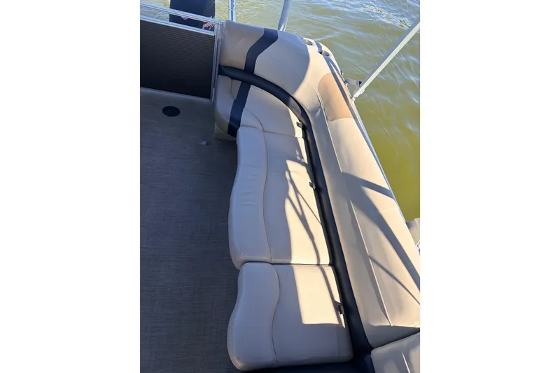 Slide: The Image of 2019 Crestliner 200 Rally CS boat with beige seating and water view. - 9