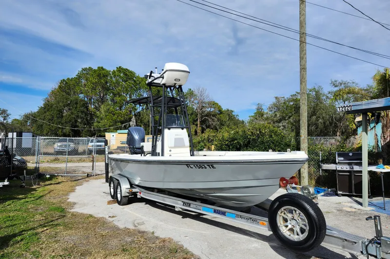 The Image of 2022 Pathfinder 2400 TRS boat on trailer, parked outdoors under clear sky. - 1