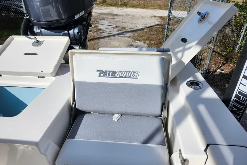 Slide: The Image of 2022 Pathfinder 2400 TRS boat interior with seating and storage compartments. - 13