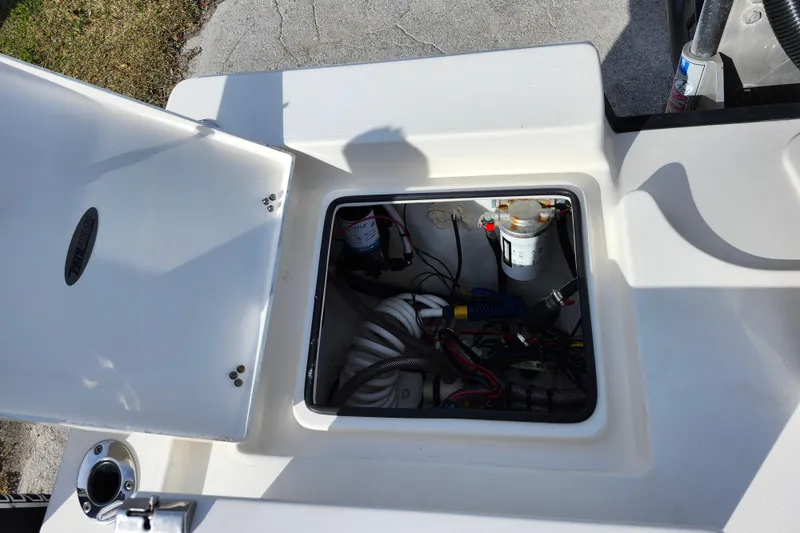 Slide: The Image of Open hatch of 2022 Pathfinder 2400 TRS boat showing internal wiring and components. - 15