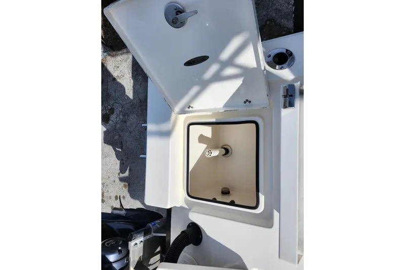 Slide: The Image of Open storage compartment on a 2022 Pathfinder 2400 TRS boat, showing interior details. - 16