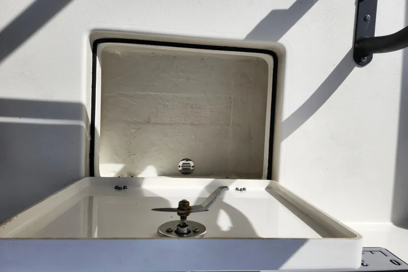 Slide: The Image of Open storage compartment on 2022 Pathfinder 2400 TRS boat, showing interior details. - 18