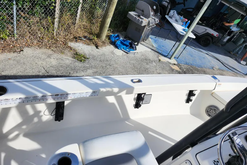 Slide: The Image of 2022 Pathfinder 2400 TRS boat interior with fishing rod holders and seating. - 21