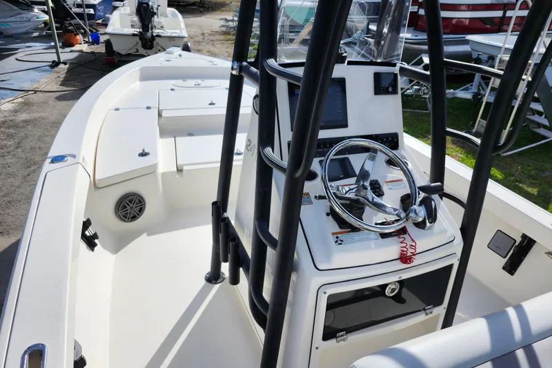 Slide: The Image of 2022 Pathfinder 2400 TRS boat interior with steering console and seating area. - 23