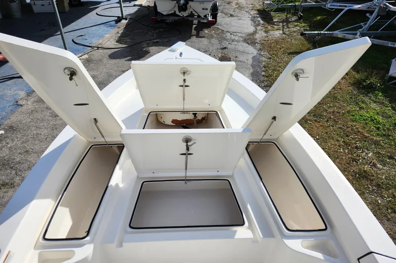 Slide: The Image of 2022 Pathfinder 2400 TRS boat with open storage compartments on deck. - 26