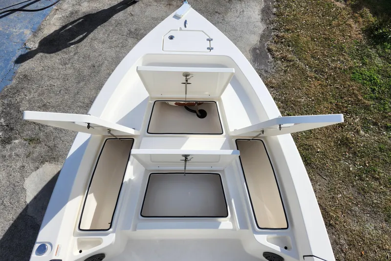 Slide: The Image of 2022 Pathfinder 2400 TRS boat with open storage compartments, viewed from above. - 27