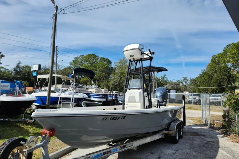 Slide: The Image of 2022 Pathfinder 2400 TRS boat on trailer, parked outdoors at a dealership. - 3