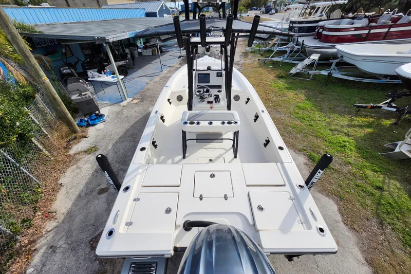 Slide: The Image of 2022 Pathfinder 2400 TRS boat, aerial view, docked with visible console and seating. - 37
