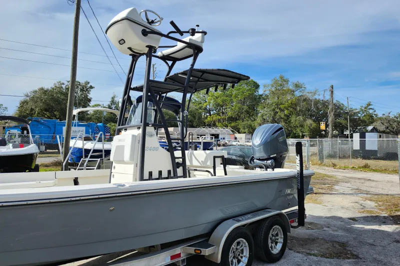 Slide: The Image of 2022 Pathfinder 2400 TRS boat on trailer, featuring a sleek design and powerful outboard motor. - 4
