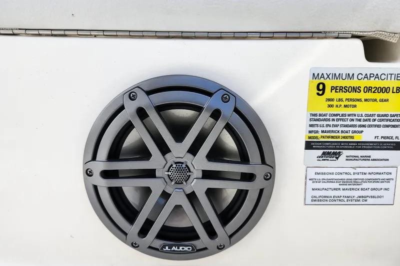 Slide: The Image of Speaker and capacity label on 2022 Pathfinder 2400 TRS boat, highlighting safety standards. - 41