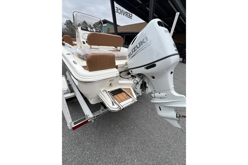 Slide: The Image of 2026 Pioneer 180 Islander boat with Suzuki outboard motor, displayed on a trailer. - 10