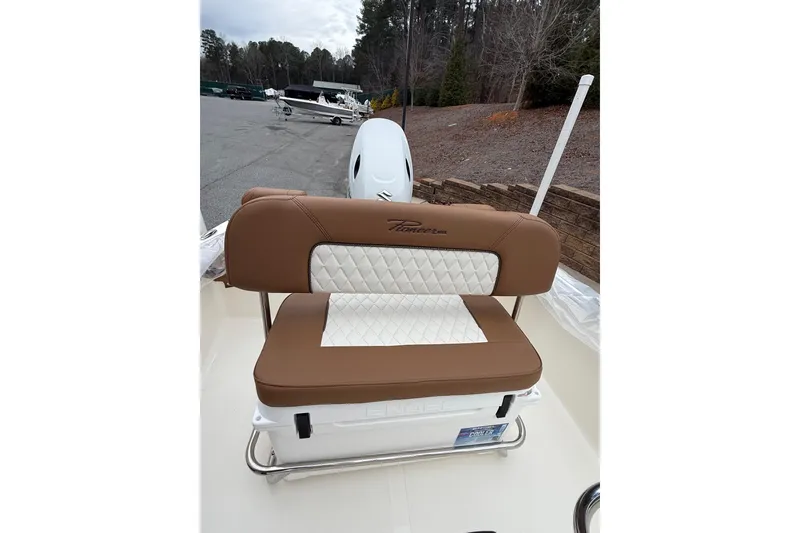 Slide: The Image of Brown and white seating on 2026 Pioneer 180 Islander boat, parked outdoors. - 7
