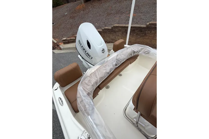 Slide: The Image of 2026 Pioneer 180 Islander boat with Suzuki outboard motor and brown seating. - 8